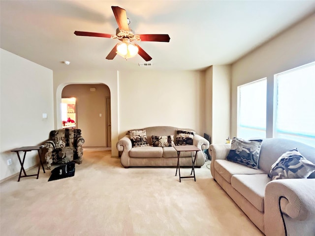 living room with ceiling fan and light colored carpet