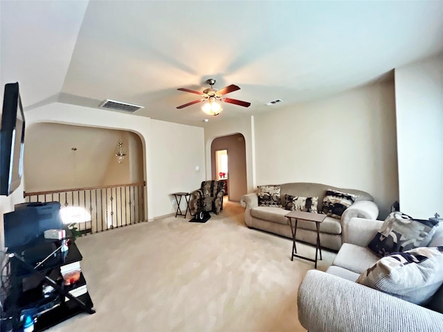 carpeted living room with ceiling fan