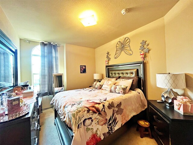 carpeted bedroom with a textured ceiling