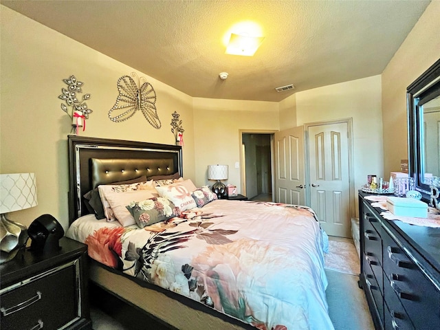 carpeted bedroom featuring sink, a textured ceiling, and a closet