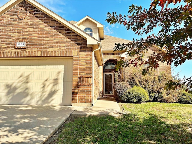 front facade with a front yard and a garage