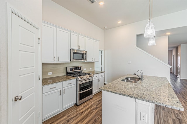 kitchen with sink, white cabinetry, tasteful backsplash, light stone countertops, and appliances with stainless steel finishes