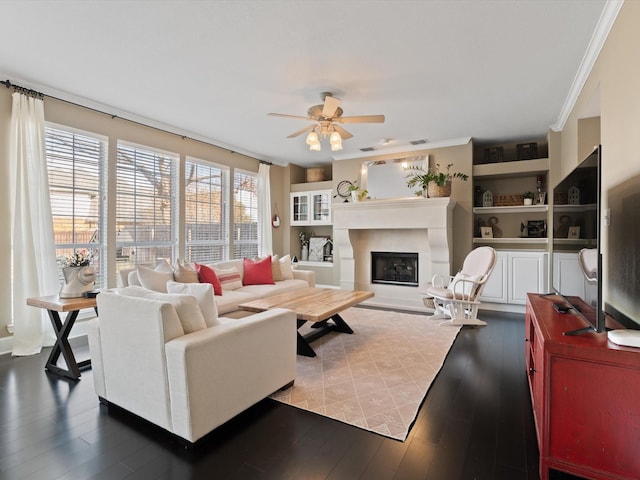 living room featuring hardwood / wood-style flooring, ceiling fan, and ornamental molding