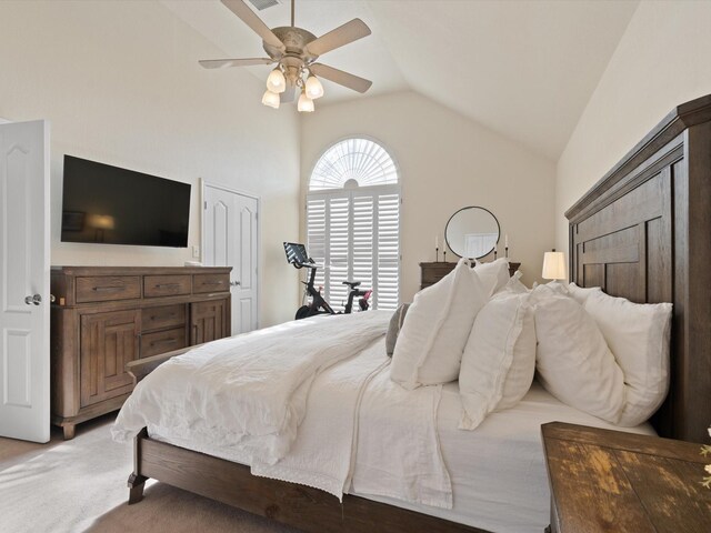 bedroom featuring ceiling fan, carpet floors, and lofted ceiling