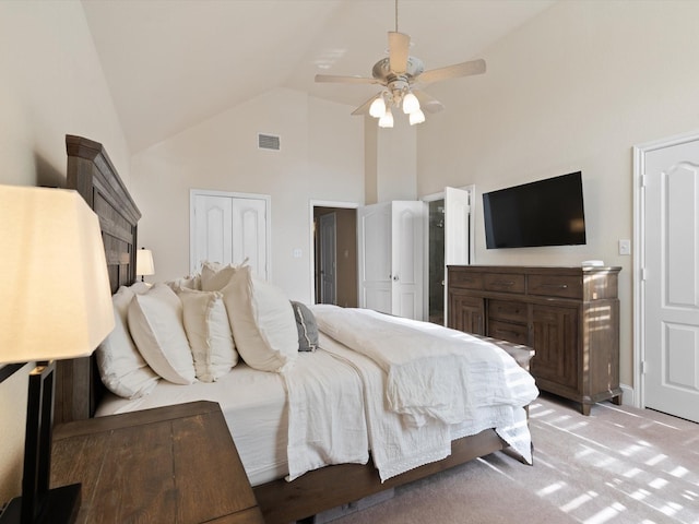 carpeted bedroom featuring ceiling fan and high vaulted ceiling