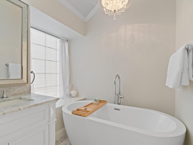 bathroom with a bathing tub, vanity, crown molding, and an inviting chandelier