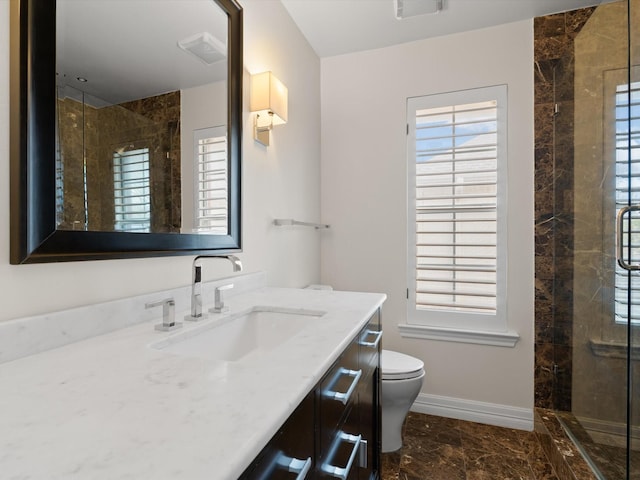 bathroom featuring vanity, toilet, and walk in shower