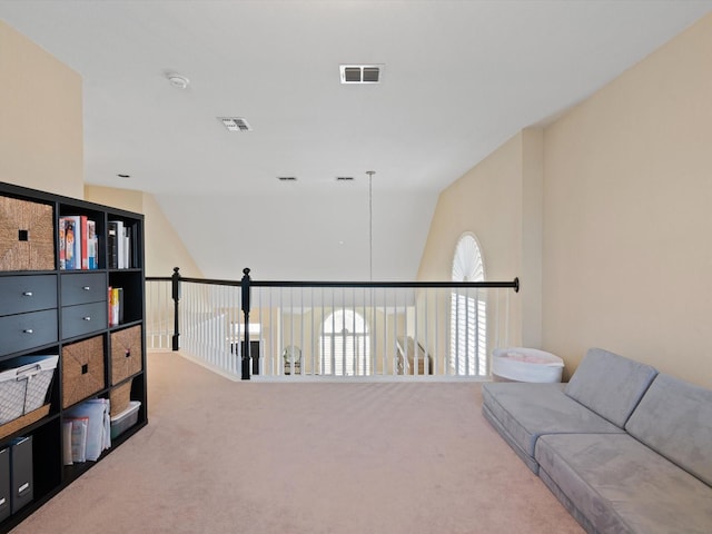 interior space featuring carpet flooring and vaulted ceiling