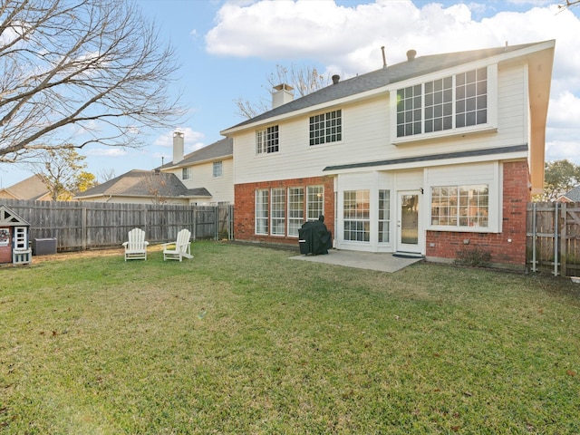 rear view of property featuring a patio and a lawn