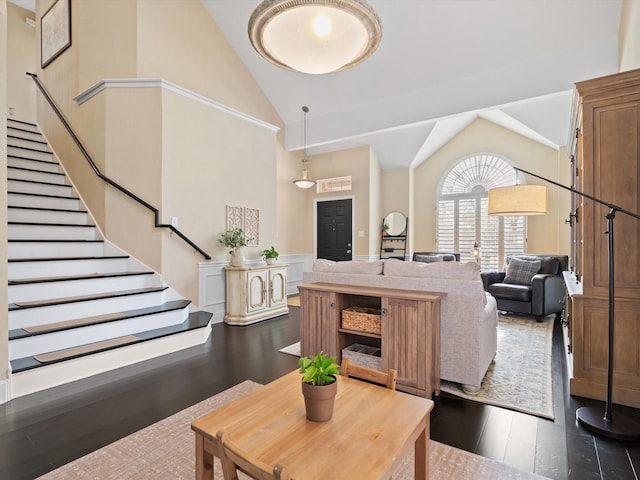 living room with dark hardwood / wood-style flooring and high vaulted ceiling