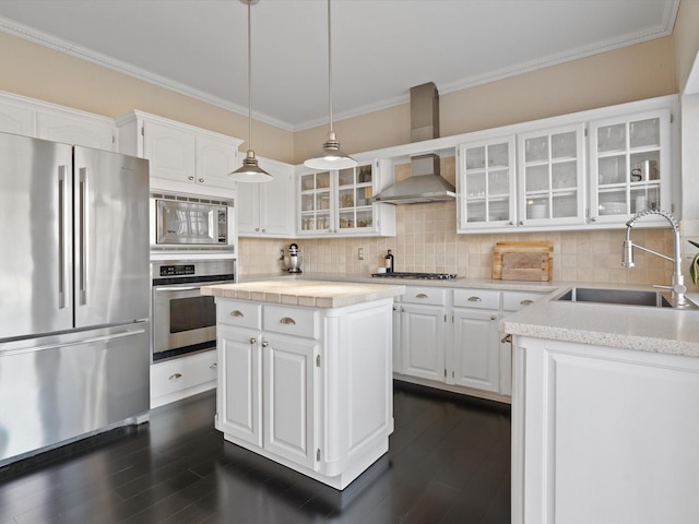 kitchen featuring a center island, sink, stainless steel appliances, decorative backsplash, and white cabinets