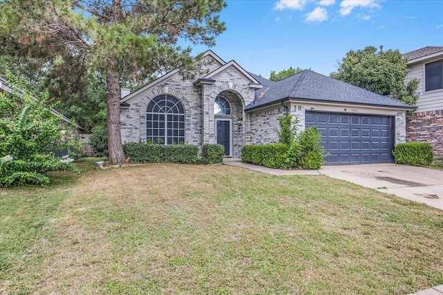 view of front of house with a garage and a front lawn