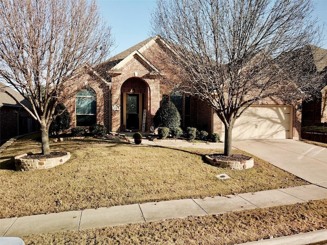 view of front of house with a garage and a front lawn