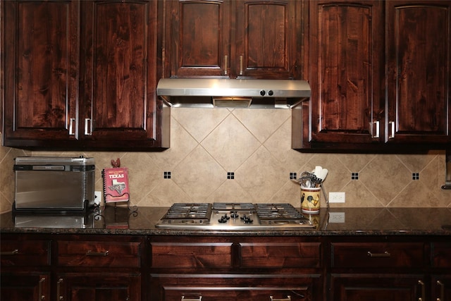 kitchen featuring stainless steel gas stovetop, dark brown cabinets, and decorative backsplash