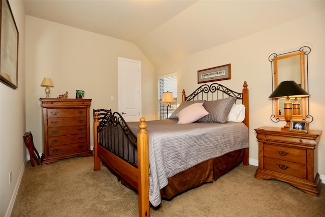 carpeted bedroom with lofted ceiling