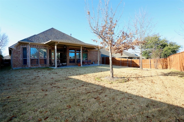 rear view of house with a yard and a patio area