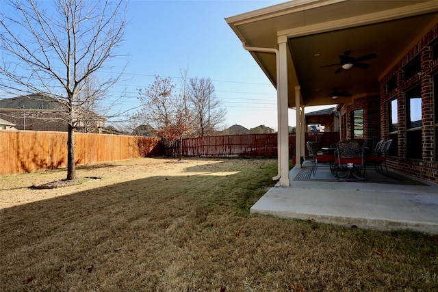 view of yard with ceiling fan and a patio area