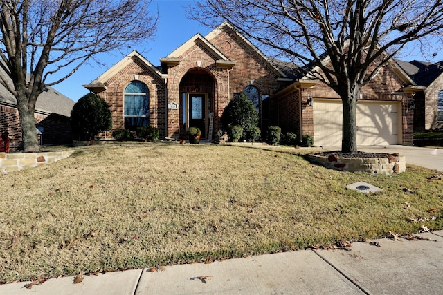 front facade featuring a garage and a front yard