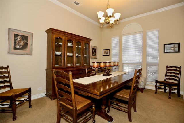 dining room with light carpet, ornamental molding, and a notable chandelier