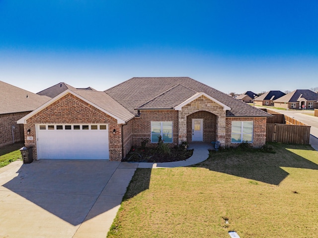 ranch-style home featuring a front lawn and a garage