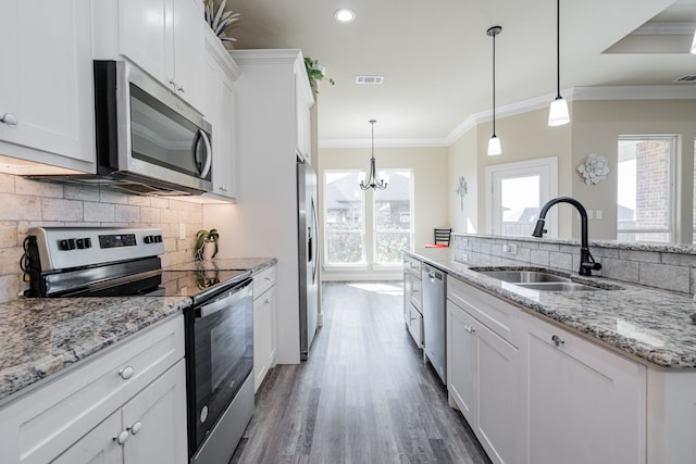 kitchen featuring white cabinetry, pendant lighting, and appliances with stainless steel finishes