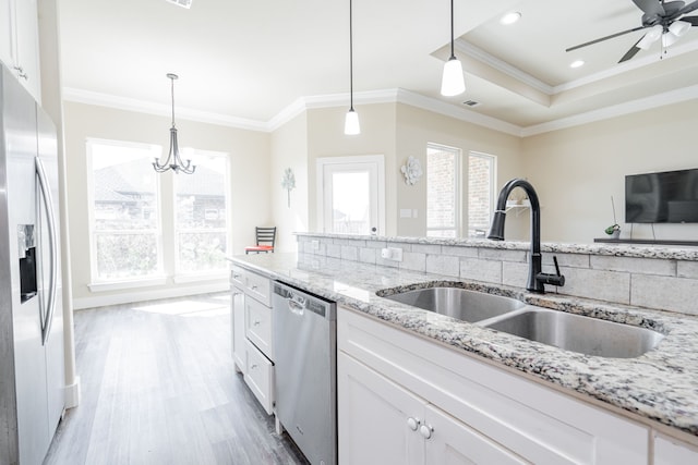 kitchen with sink, white cabinetry, stainless steel appliances, and ornamental molding