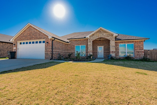 view of front of house featuring a garage and a front lawn