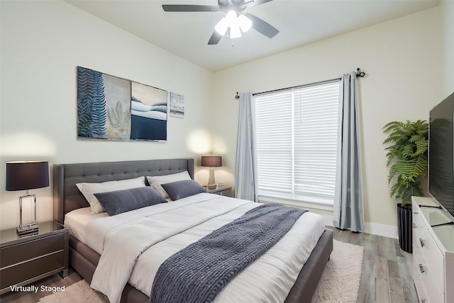 bedroom featuring light hardwood / wood-style floors and ceiling fan