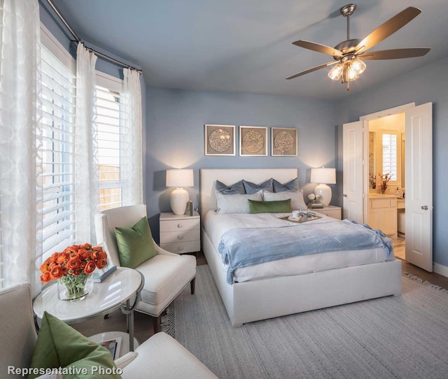 bedroom featuring ceiling fan and ensuite bath