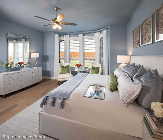 bedroom featuring ceiling fan, access to exterior, and light hardwood / wood-style floors