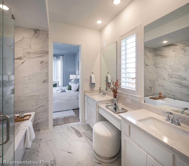 bathroom with plus walk in shower, tile walls, and vanity