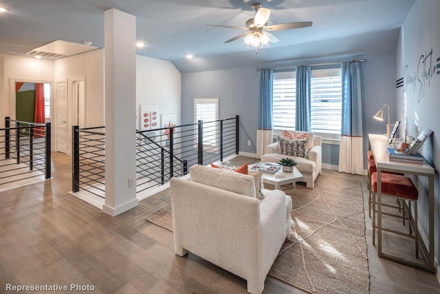 living room featuring lofted ceiling, wood-type flooring, and ceiling fan