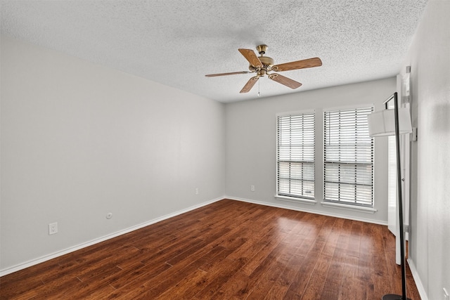 empty room featuring a textured ceiling, ceiling fan, and dark wood-type flooring