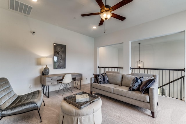 carpeted living room featuring ceiling fan