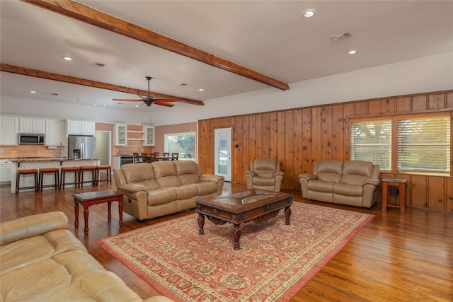 7425 Hickey Rd, Azle, TX 76020 - living area featuring wood walls, beamed ceiling, wood finished floors, a ceiling fan, and recessed lighting