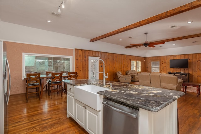 kitchen with stainless steel appliances, ceiling fan, sink, beamed ceiling, and white cabinetry