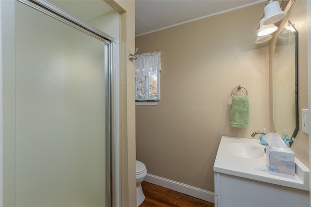 bathroom with wood-type flooring, an enclosed shower, toilet, vanity, and ornamental molding