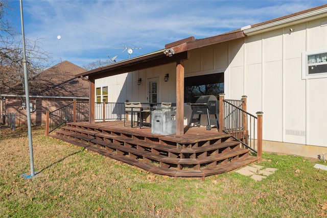 back of property featuring a lawn and a wooden deck