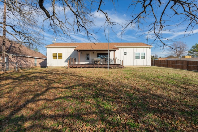 back of house with a lawn and a wooden deck