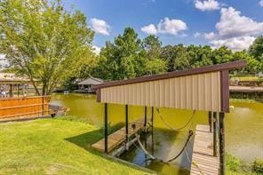 dock area with a water view and a yard