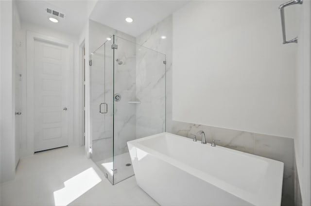 full bathroom featuring a freestanding tub, recessed lighting, a marble finish shower, and visible vents