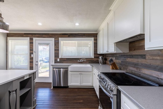 kitchen featuring sink, white cabinets, ornamental molding, and appliances with stainless steel finishes