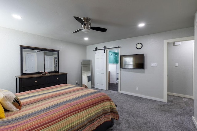 carpeted bedroom featuring a barn door and ceiling fan