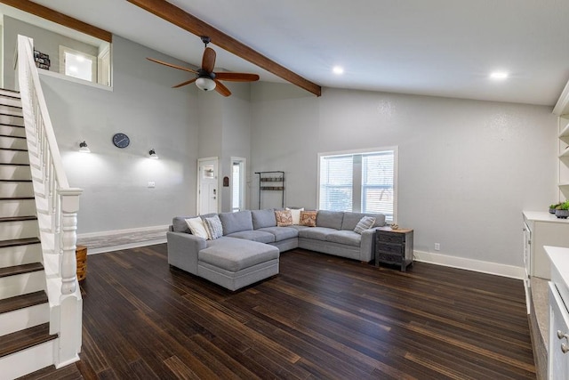 living room with a towering ceiling, ceiling fan, dark hardwood / wood-style flooring, and beamed ceiling