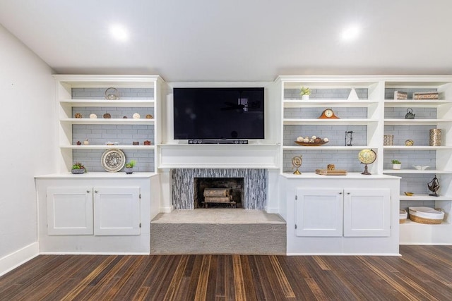 unfurnished living room with dark hardwood / wood-style flooring