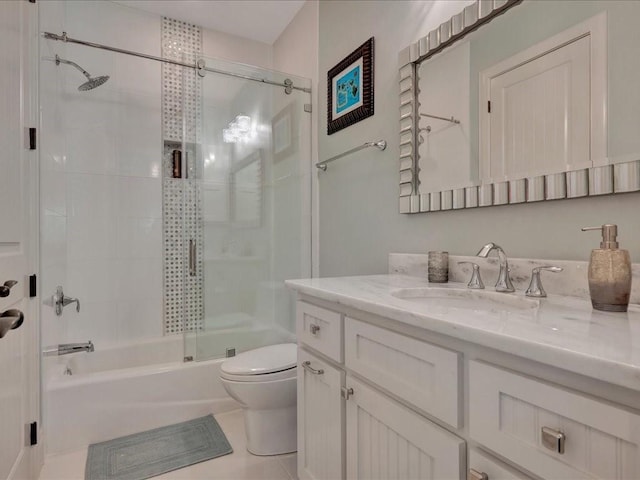 full bath with tile patterned floors, enclosed tub / shower combo, toilet, and vanity