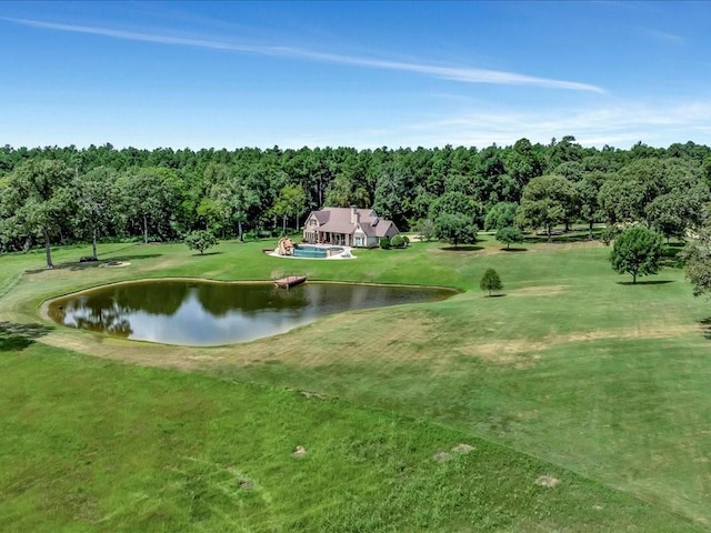 surrounding community with a water view and a lawn