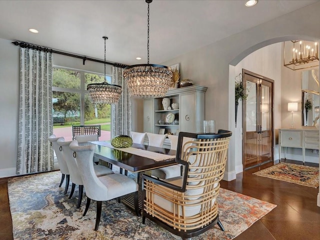 dining room with arched walkways, a chandelier, recessed lighting, and baseboards