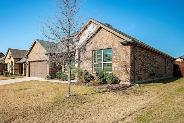 view of front of home with a front yard and a garage