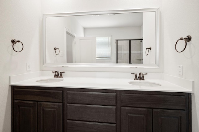 bathroom with vanity and a shower with shower door